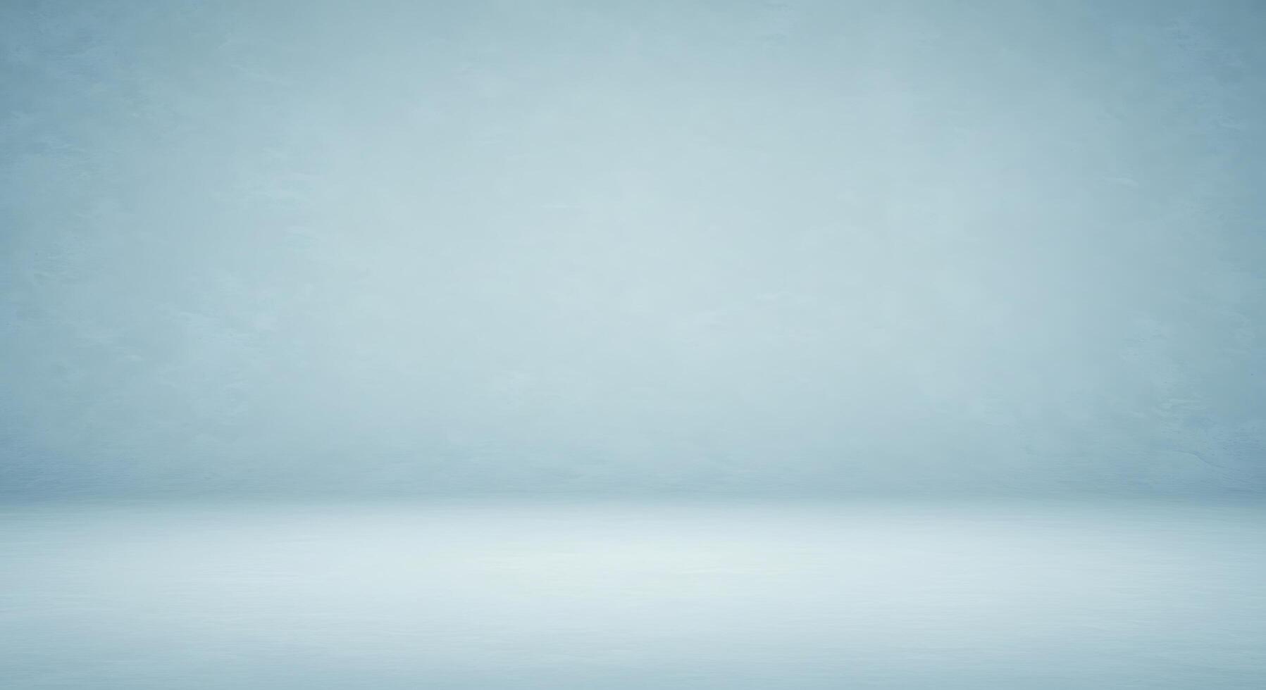 An empty room with a blue wall and a white floor photo