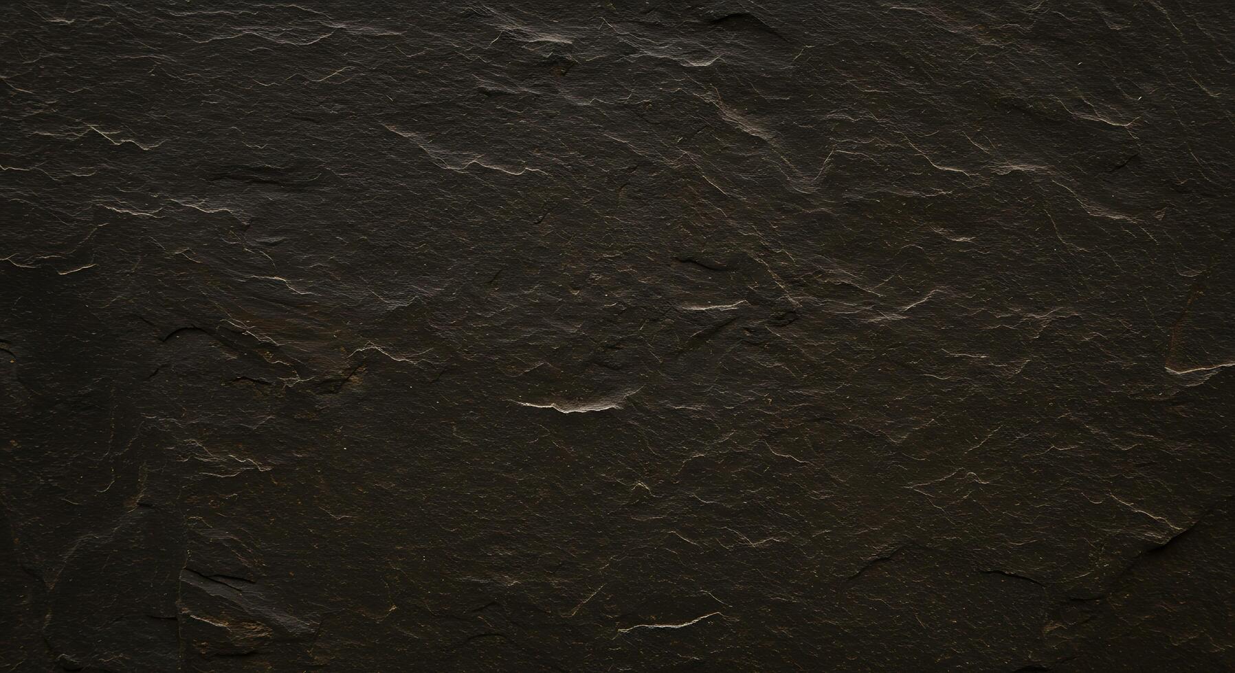 A black stone wall with some scratches on it photo