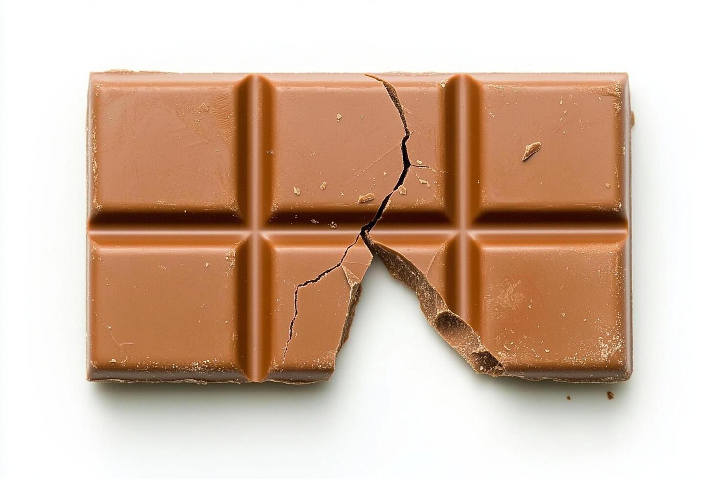 A piece of chocolate is shown on a white surface photo