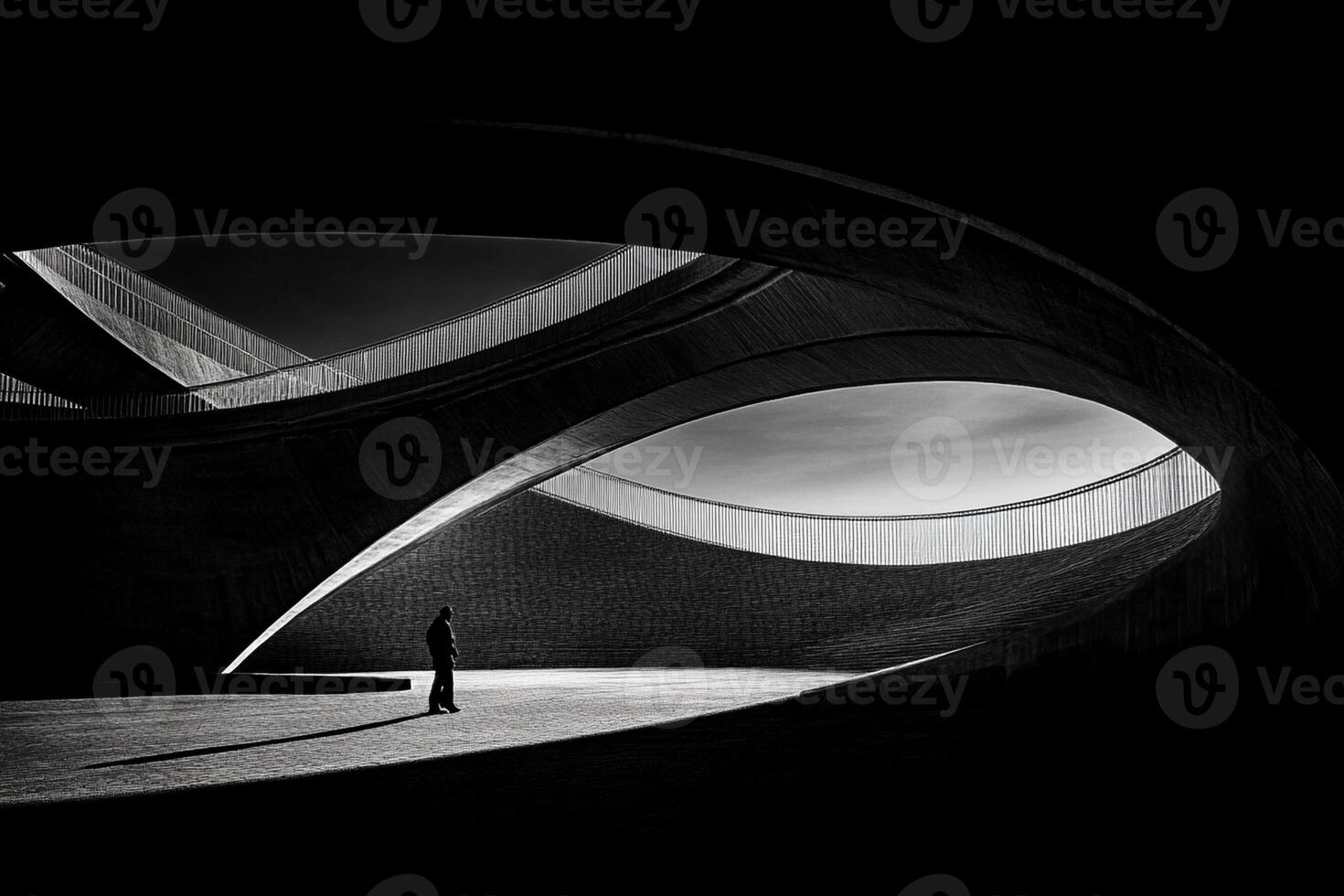 A man stands in front of a curved building photo