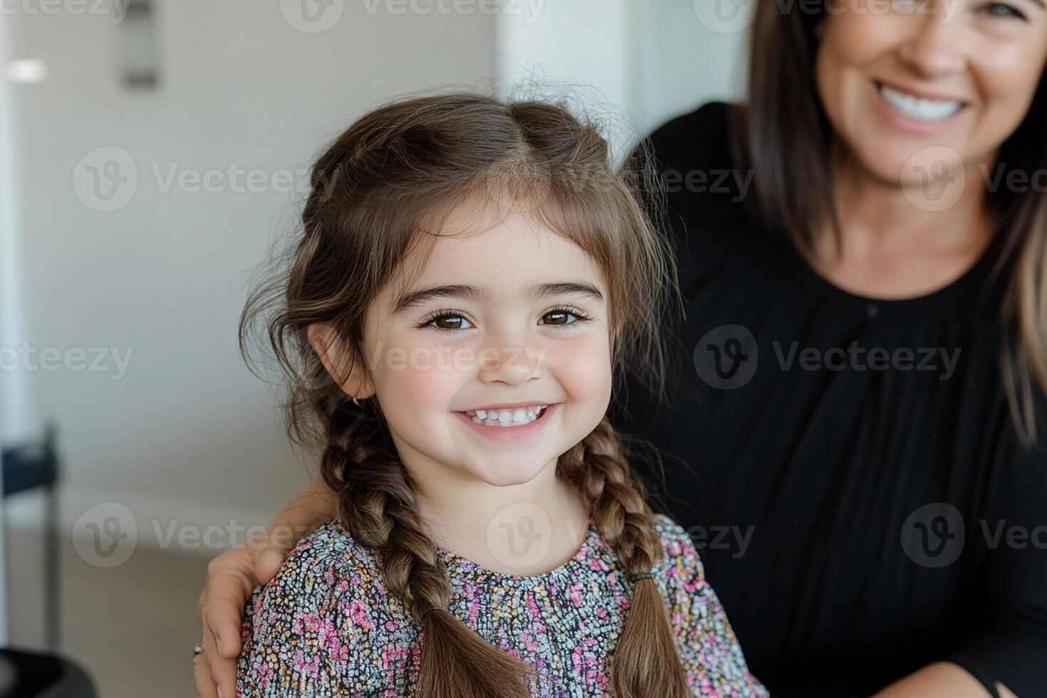 A woman and a little girl smile for the camera photo