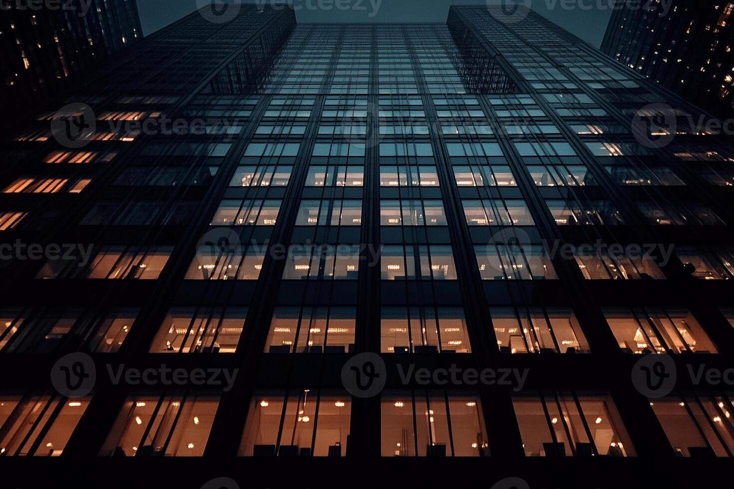 A tall building with windows lit up at night photo