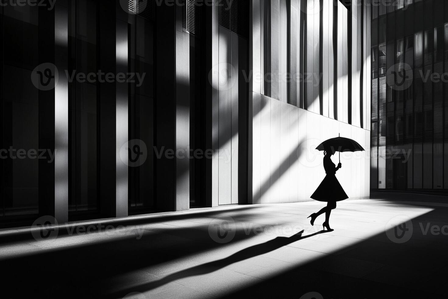 A woman is walking in the shadows with an umbrella photo