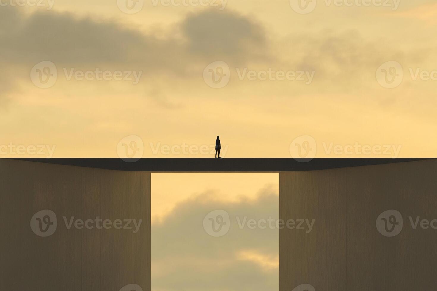 A man stands on a bridge over a large gap photo
