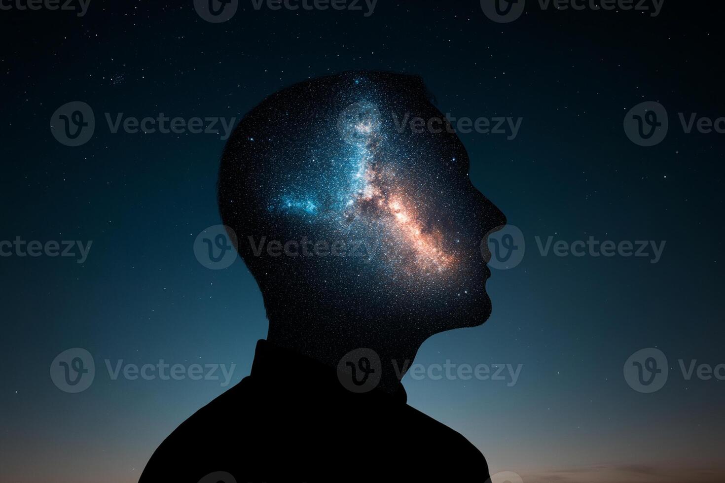 The silhouette of a man's head with the milky way in the background photo