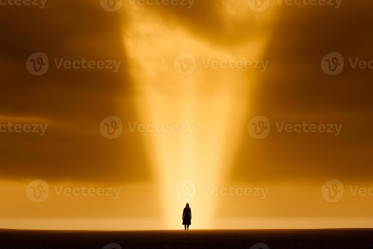 A lone person standing in front of a bright light photo