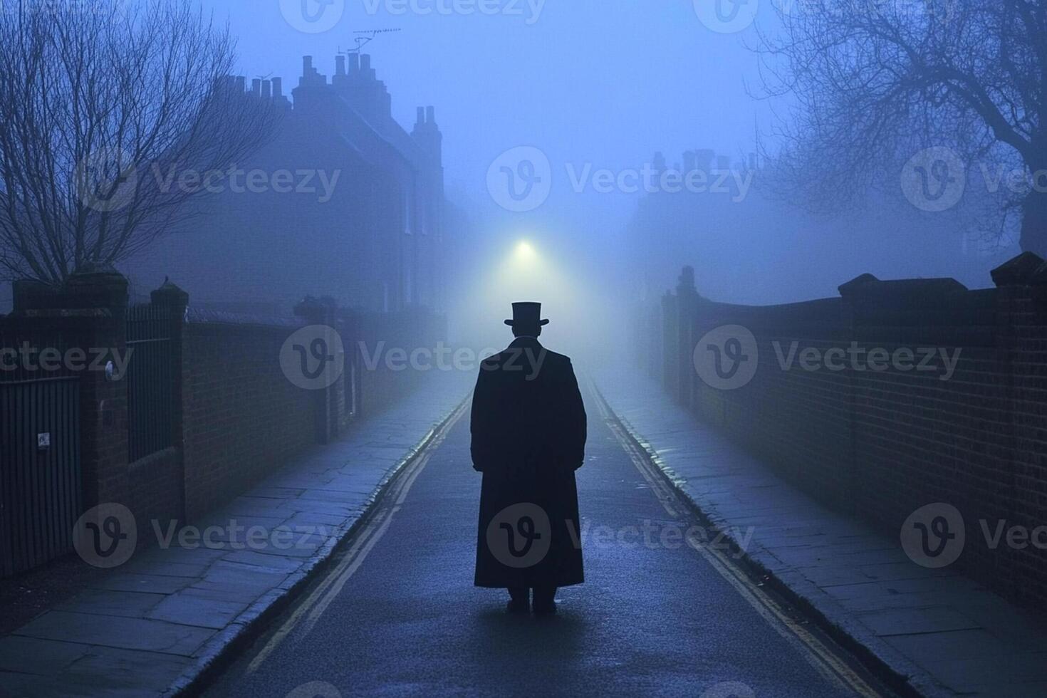 A man in a top hat and coat is walking down a foggy street photo