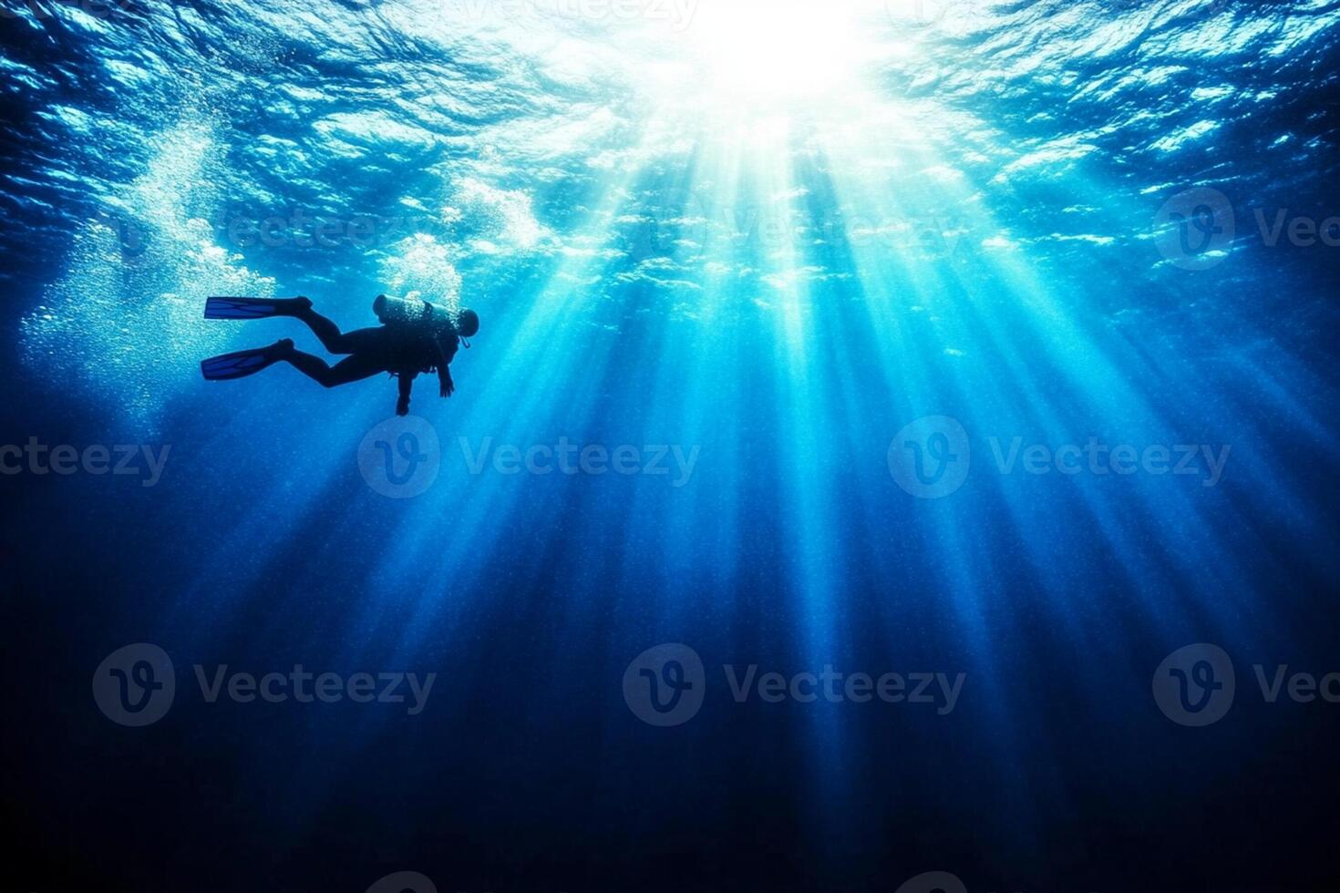 A person scuba diving in the ocean photo