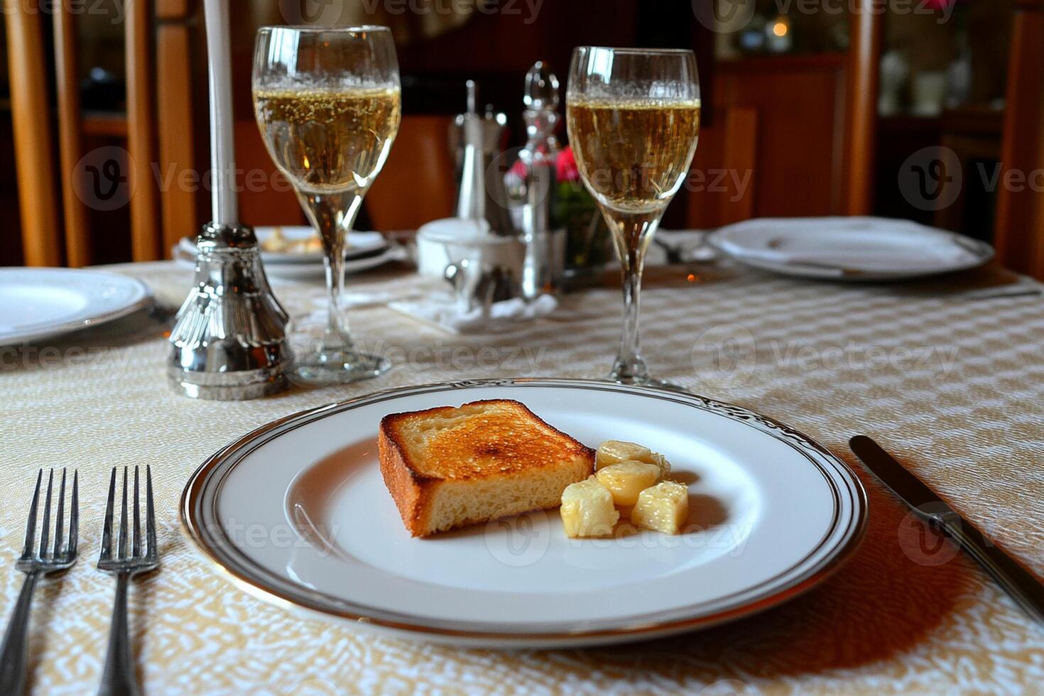 A plate with a piece of bread and a glass of champagne photo