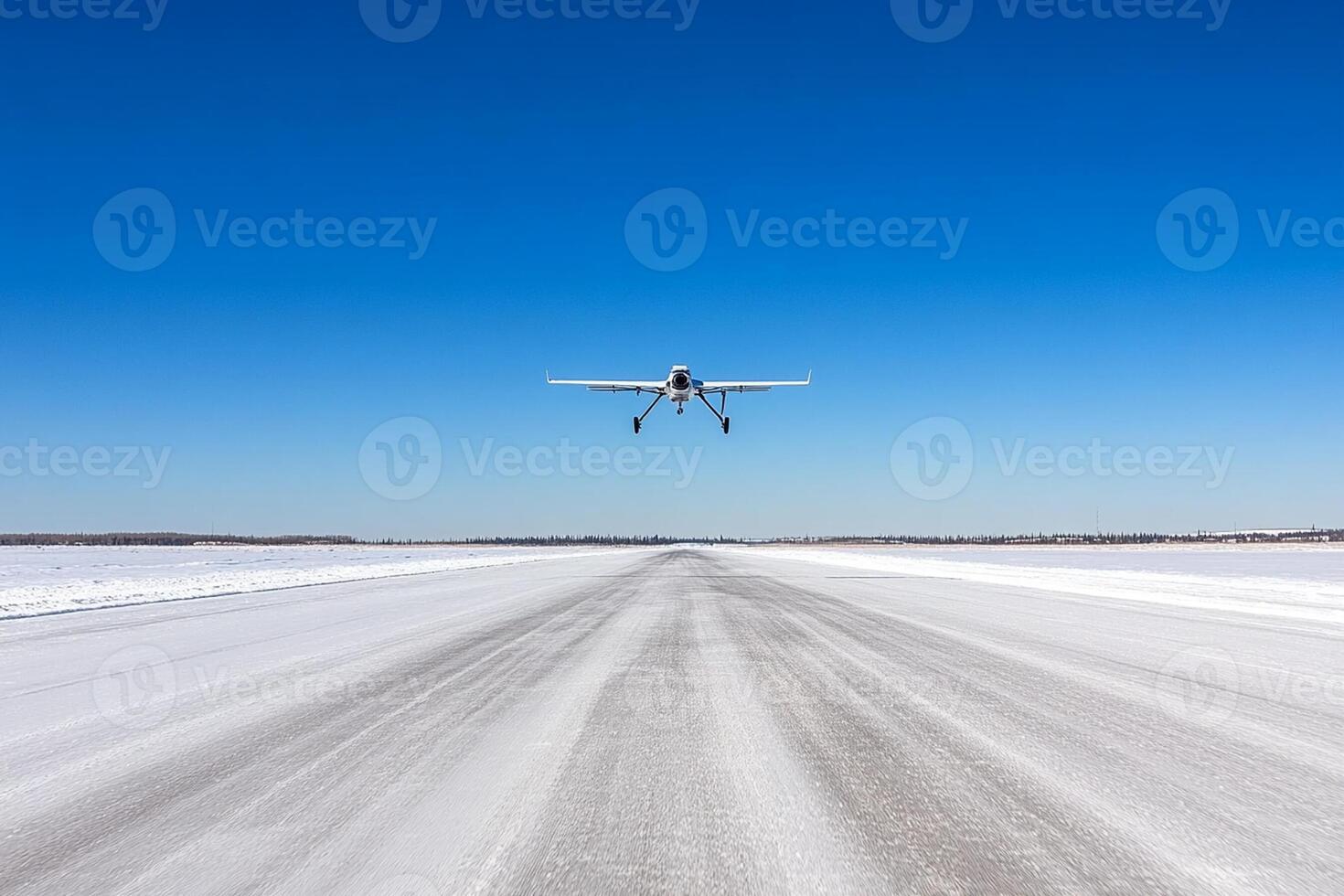 A small plane flying over a snowy road photo
