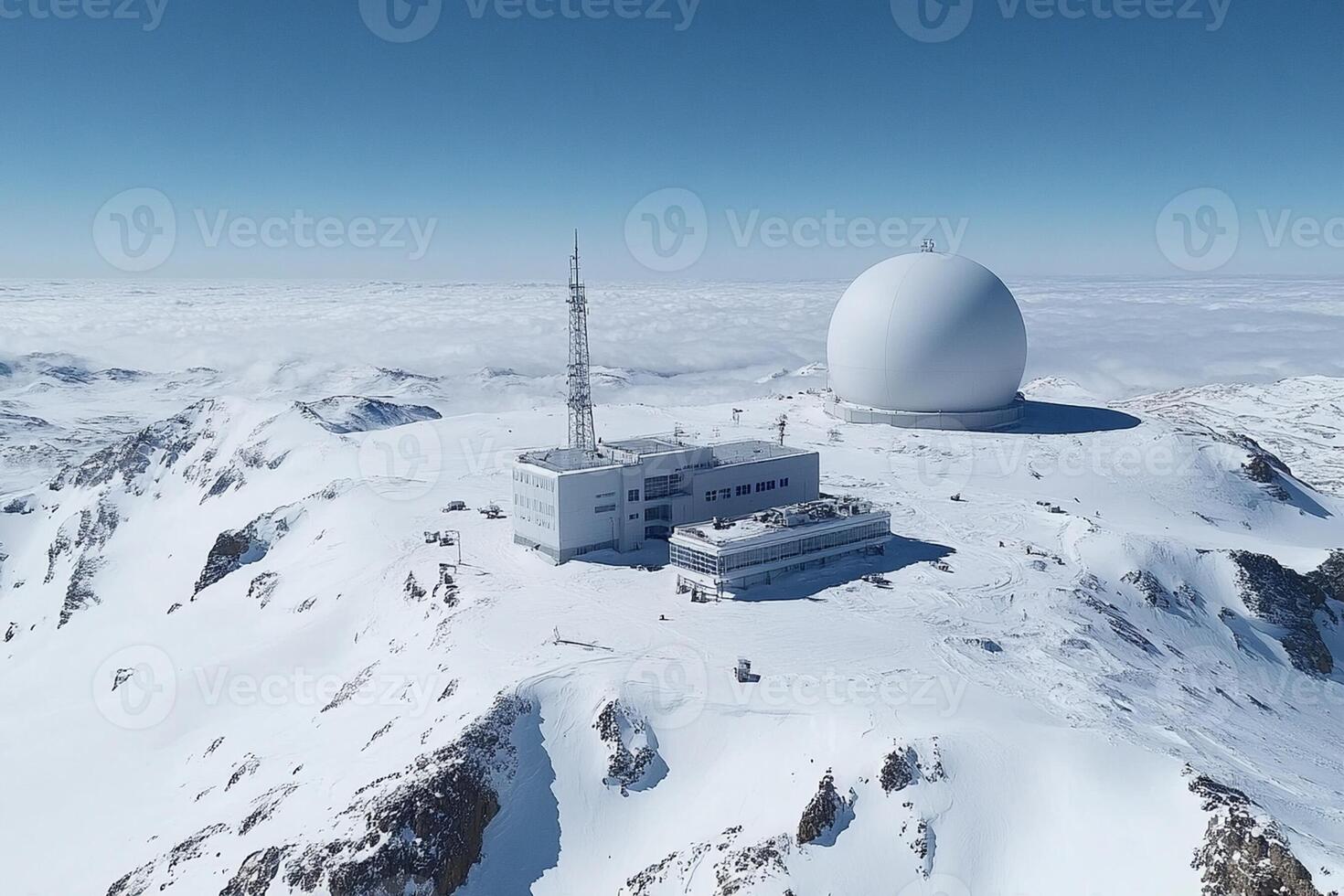 A large white dome on top of a snowy mountain photo