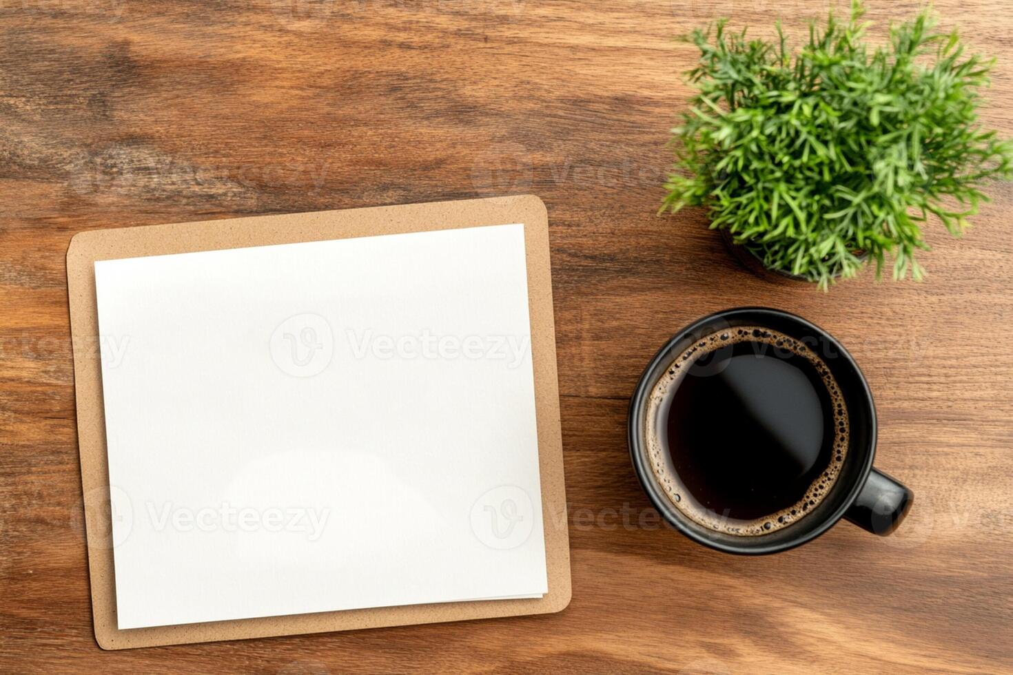 Blank paper and cup of coffee on wooden table top view photo