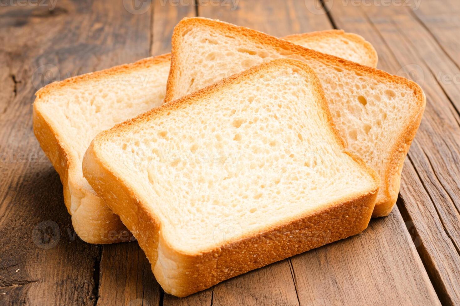 Three slices of white bread on a wooden table photo