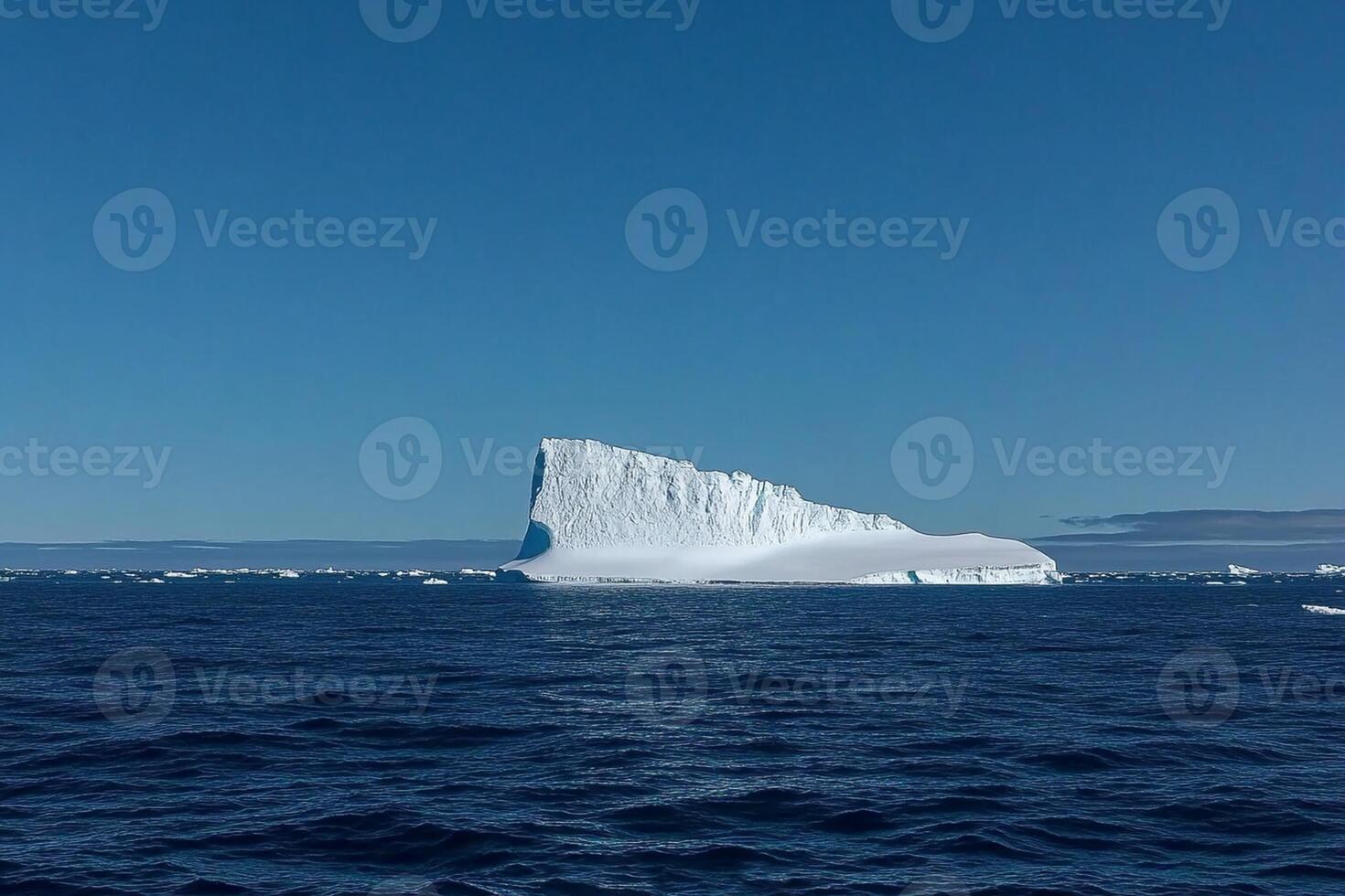 A large iceberg floating in the ocean photo