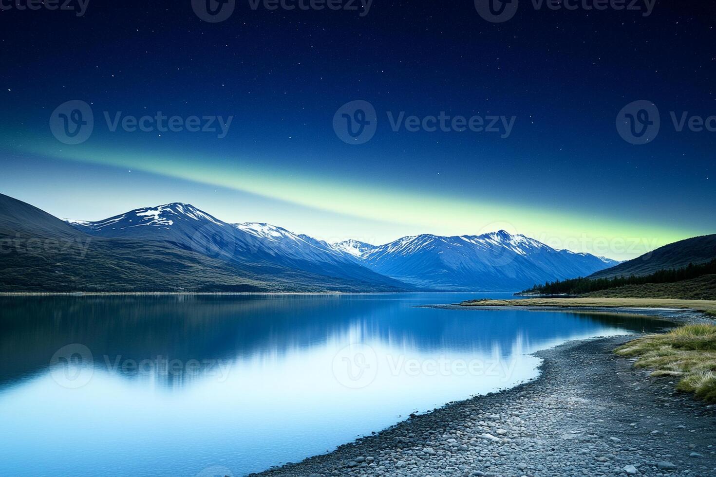 The aurora bore lights up the sky over a lake photo