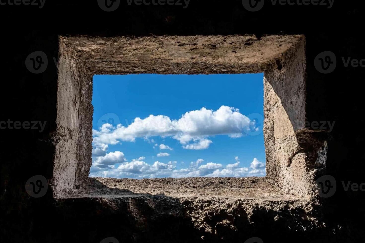 A window in an old stone building with a view of the sky photo