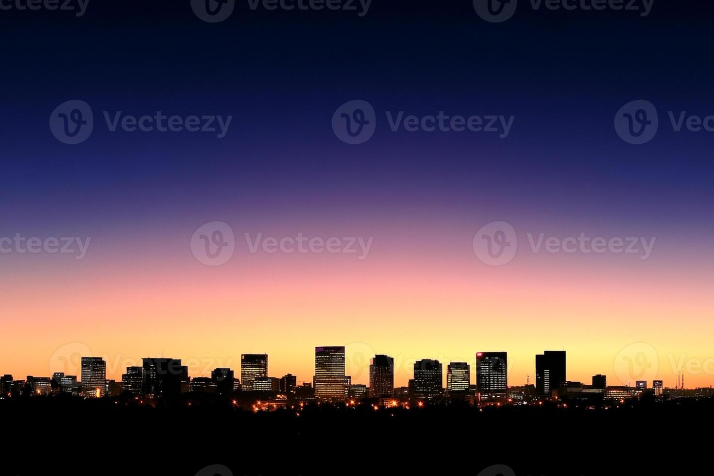 A city skyline at sunset with a blue sky photo