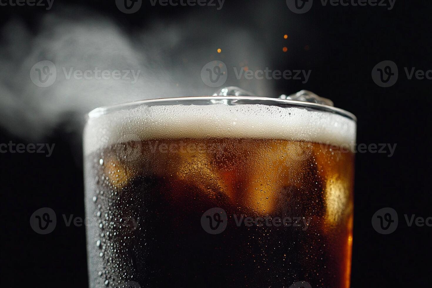 A glass of cola with ice and steam photo