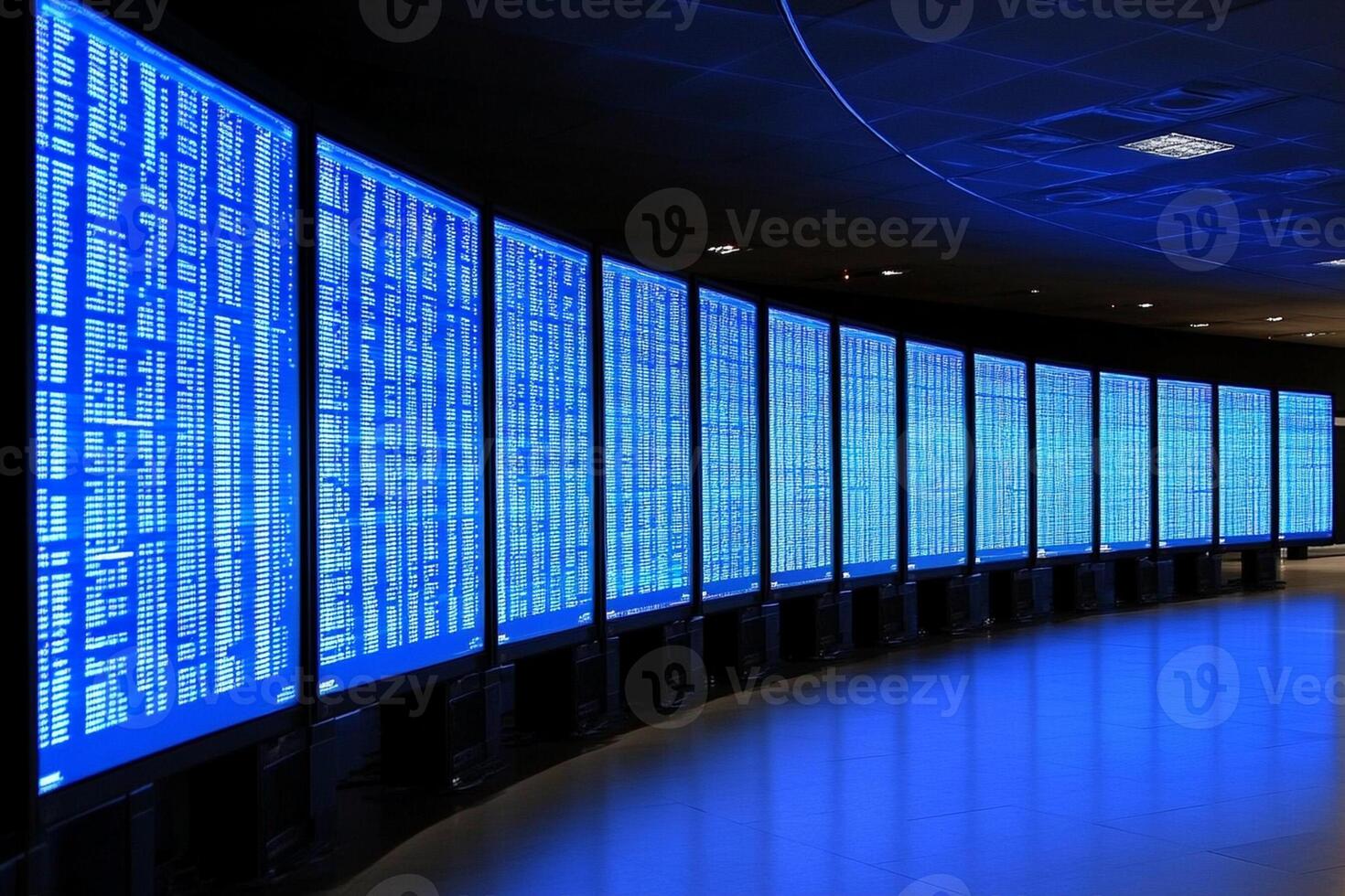 A long row of blue screens in a large room photo