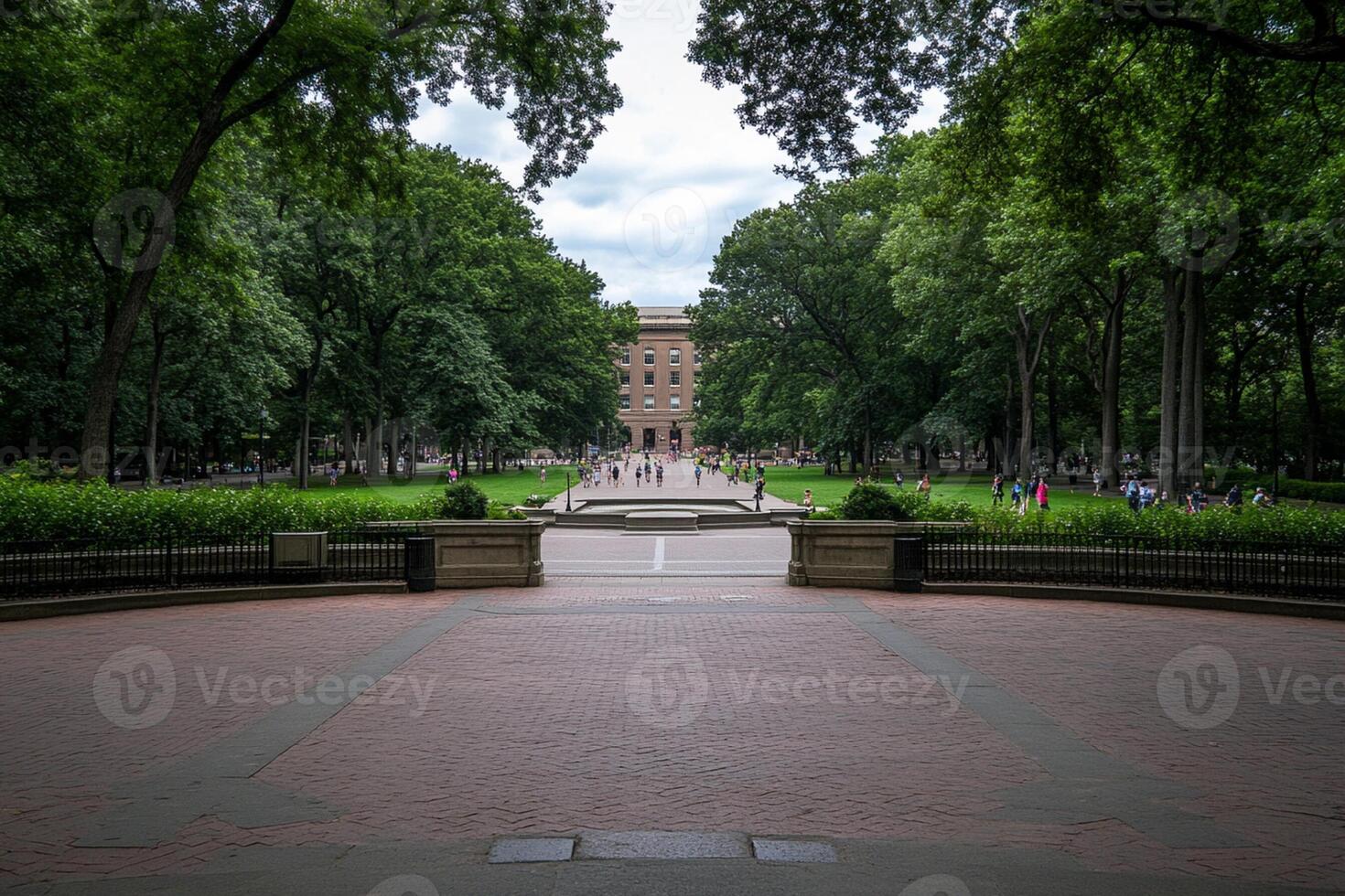A brick walkway leads to a large building photo