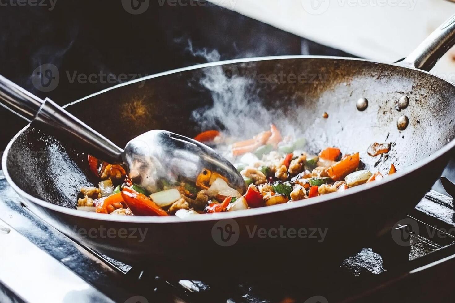 A wok with vegetables cooking on the stove photo