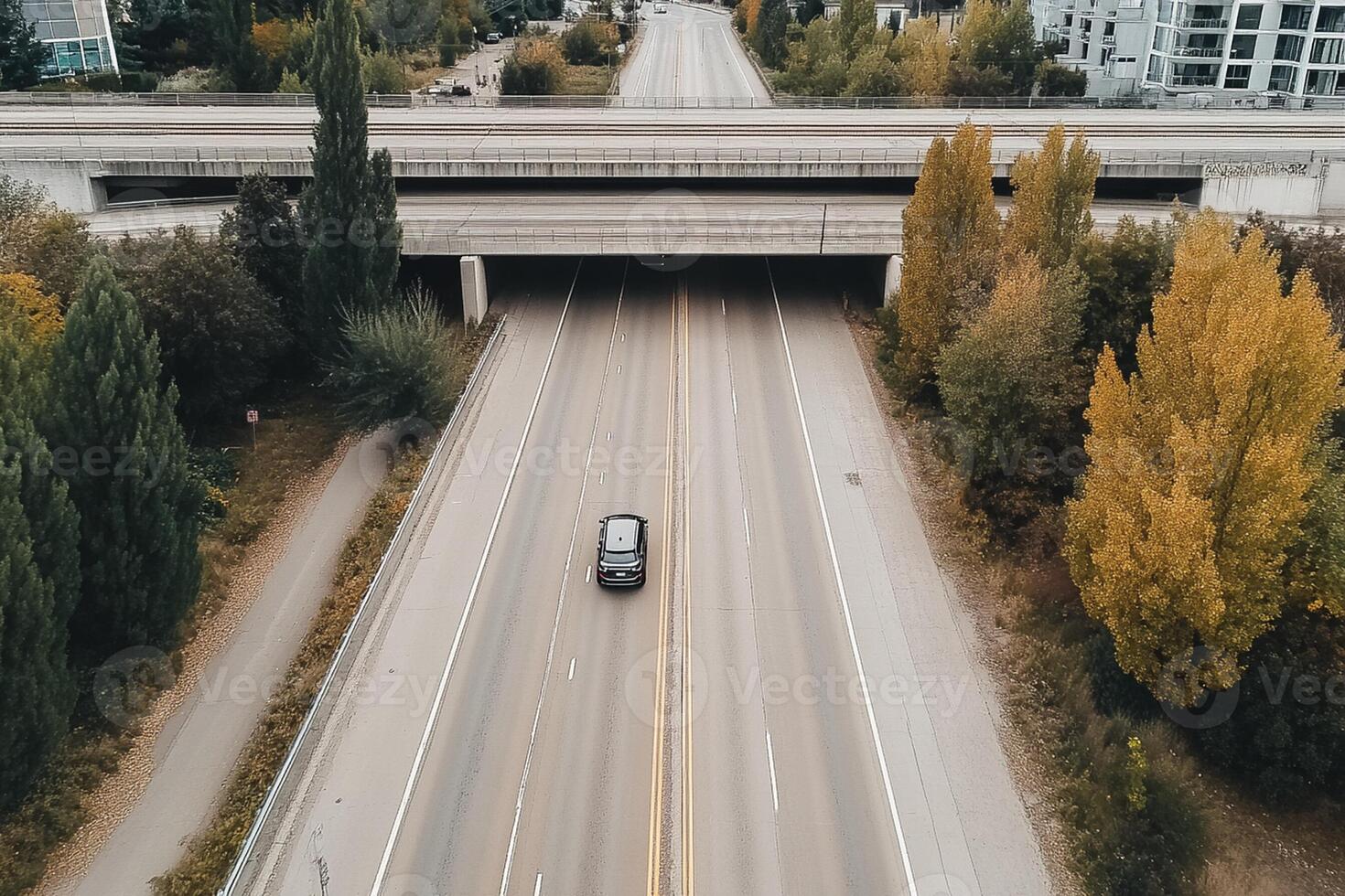 An aerial view of a car driving on a highway photo
