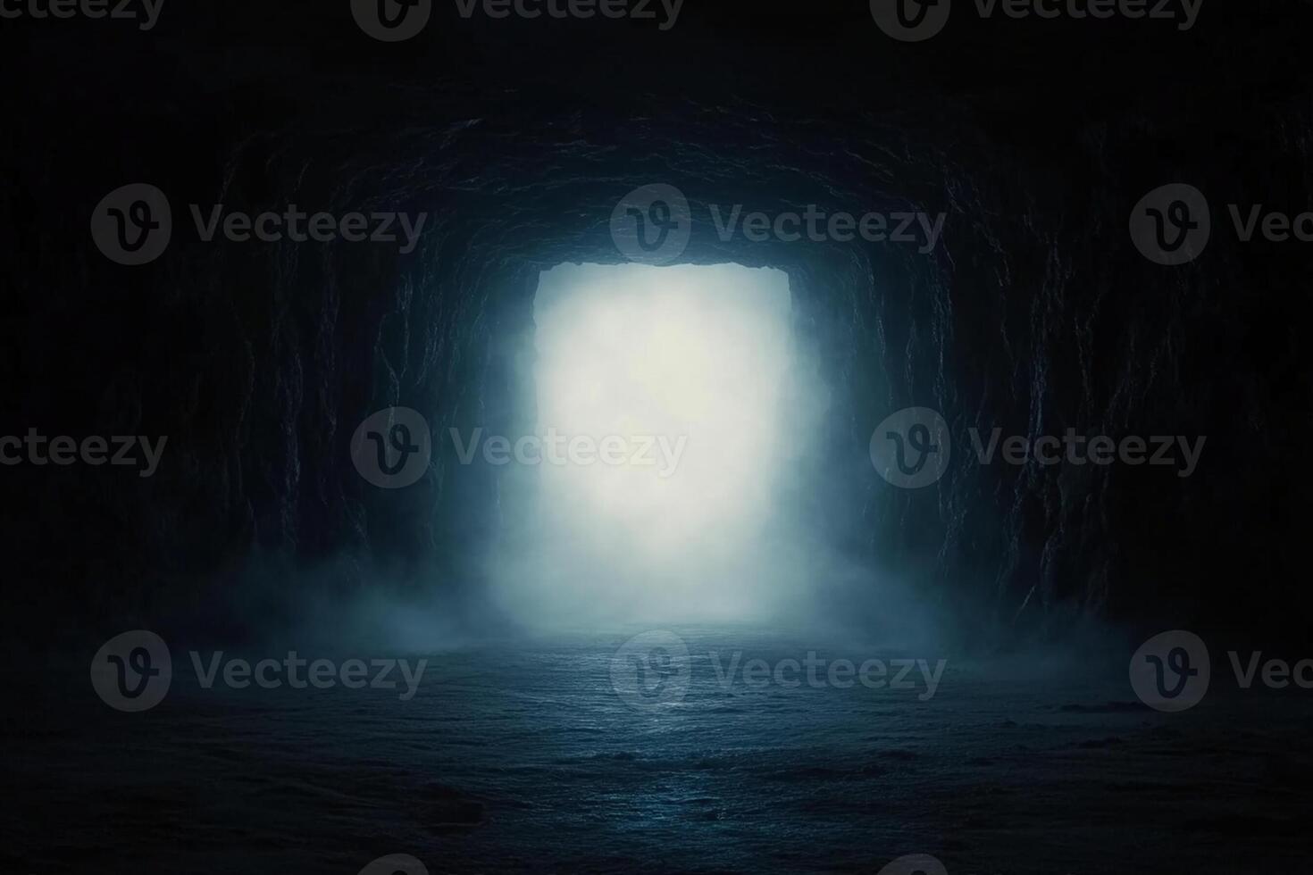 A dark tunnel with a light coming out of it photo