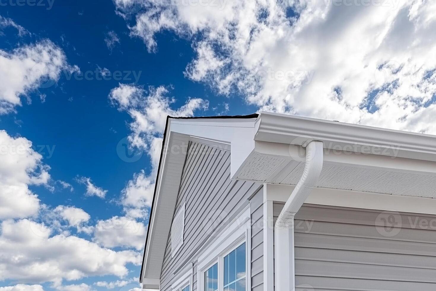 A house with a gutter and a blue sky photo