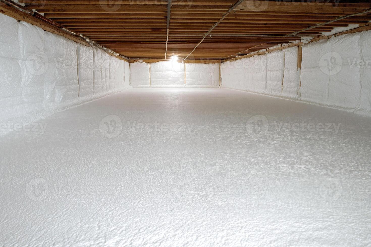 A large room with white insulation and a light shining through photo