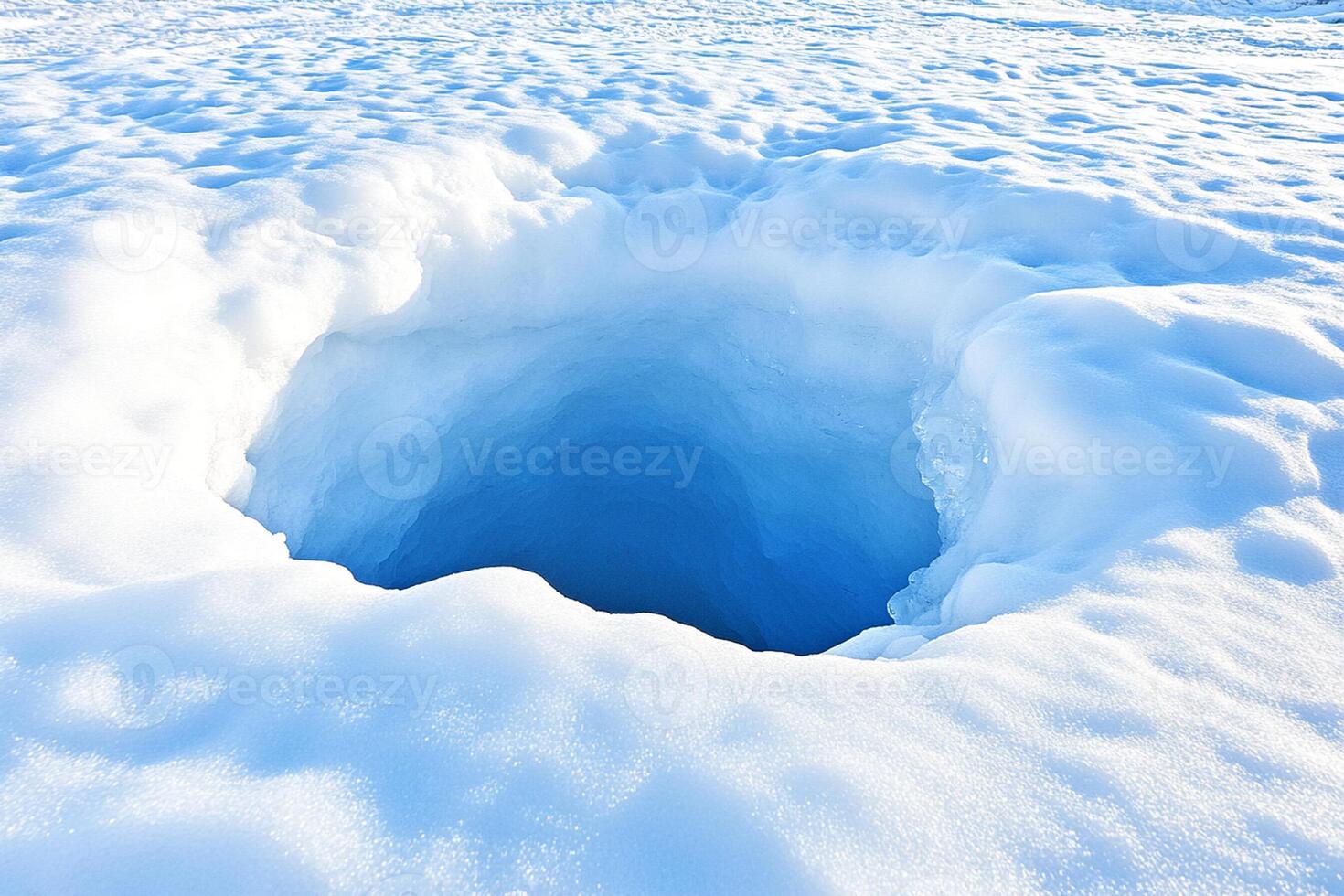 A hole in the snow with a blue sky photo