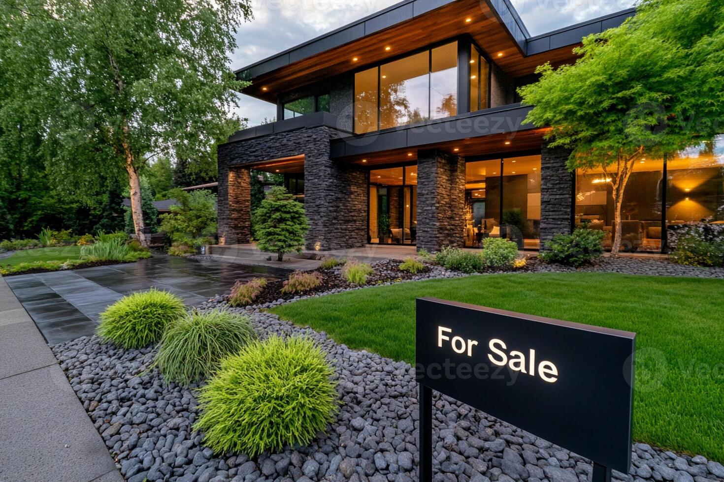 A modern home with a for sale sign in front photo