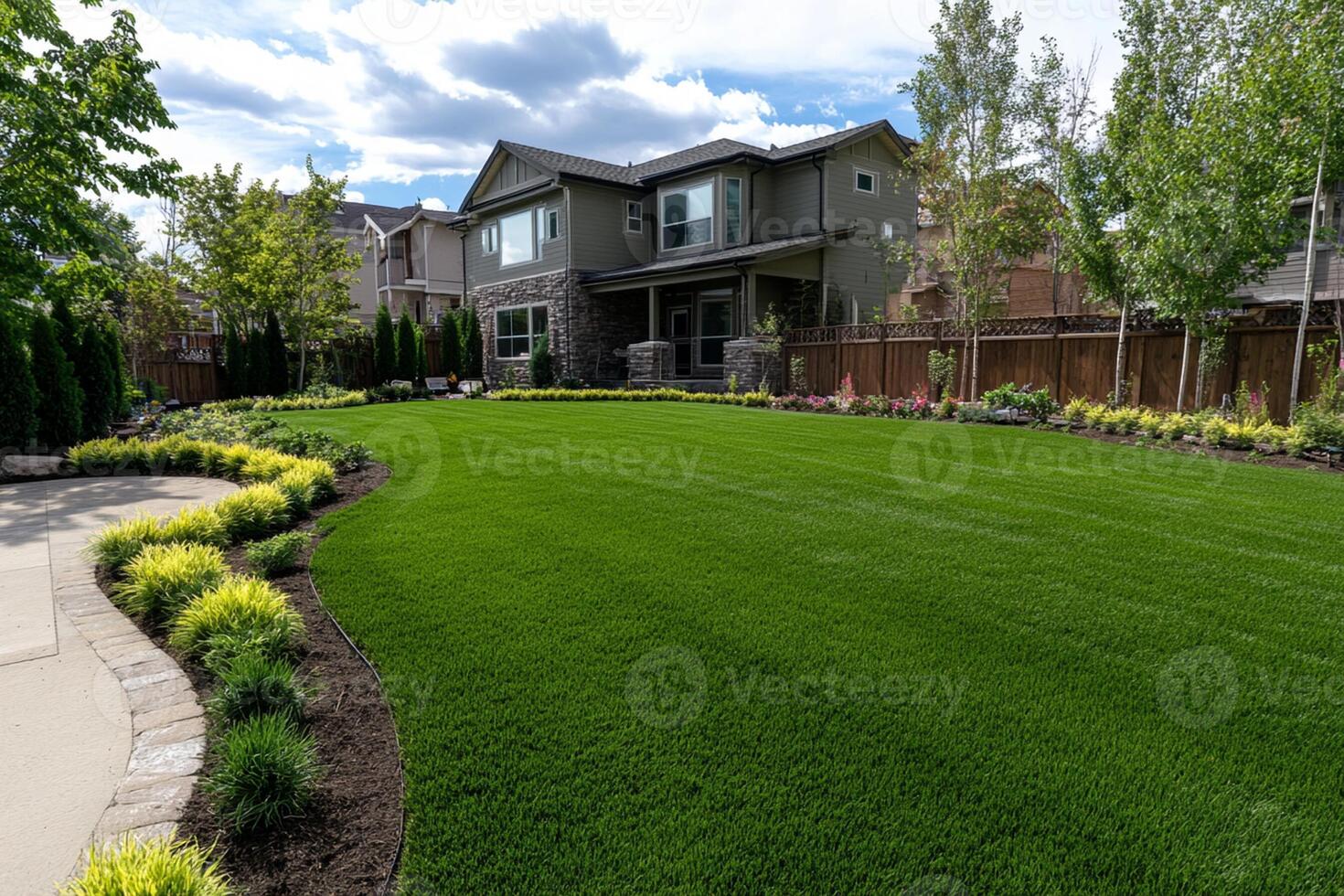 A beautiful backyard with a lawn and landscaping photo