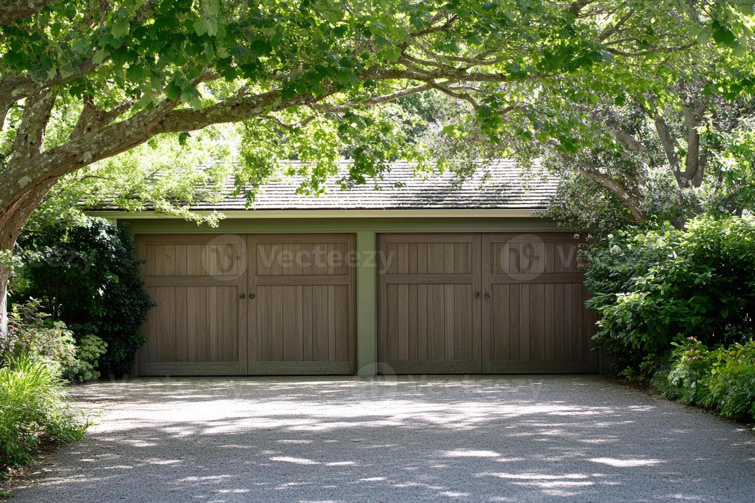 A large garage with two doors and trees photo