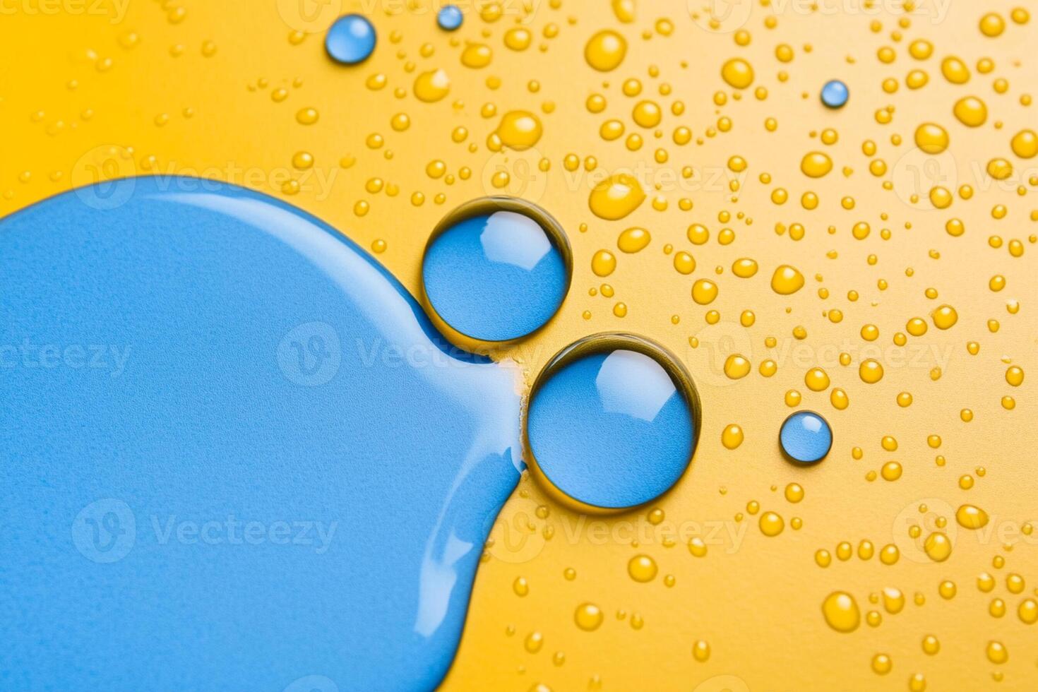 Blue and yellow liquid drops on a yellow background photo