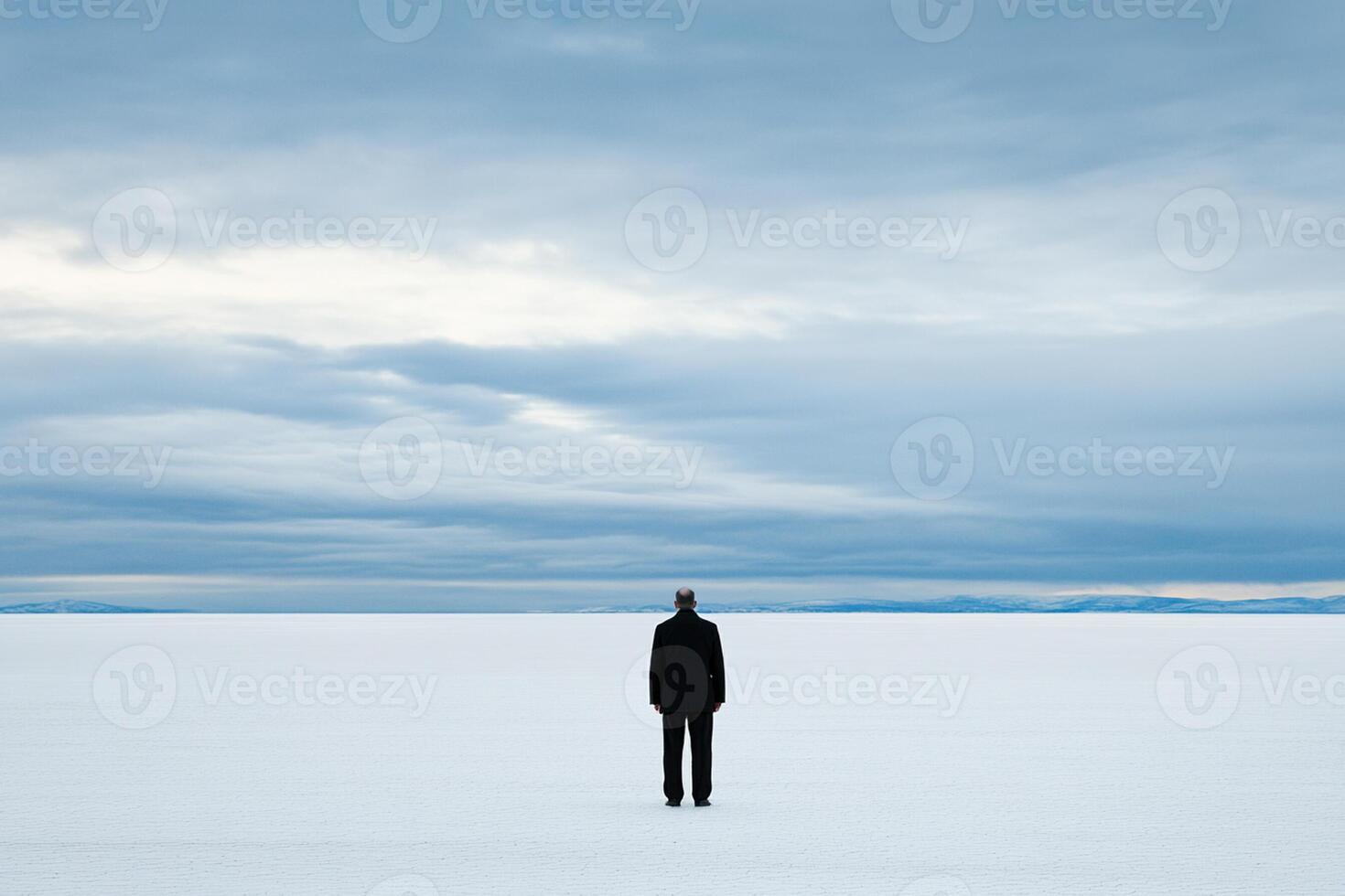 A man standing in the middle of a large field photo