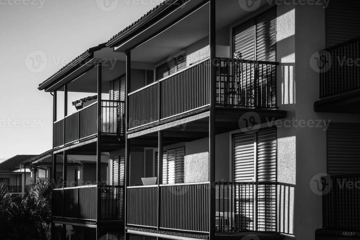 A black and white photo of a building with balconies