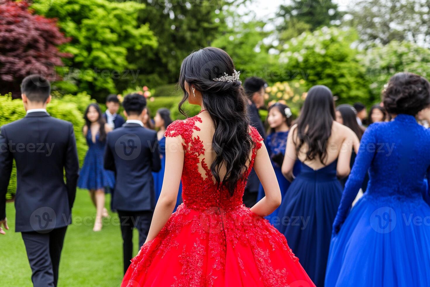 A woman in a red dress walking through a crowd of people photo