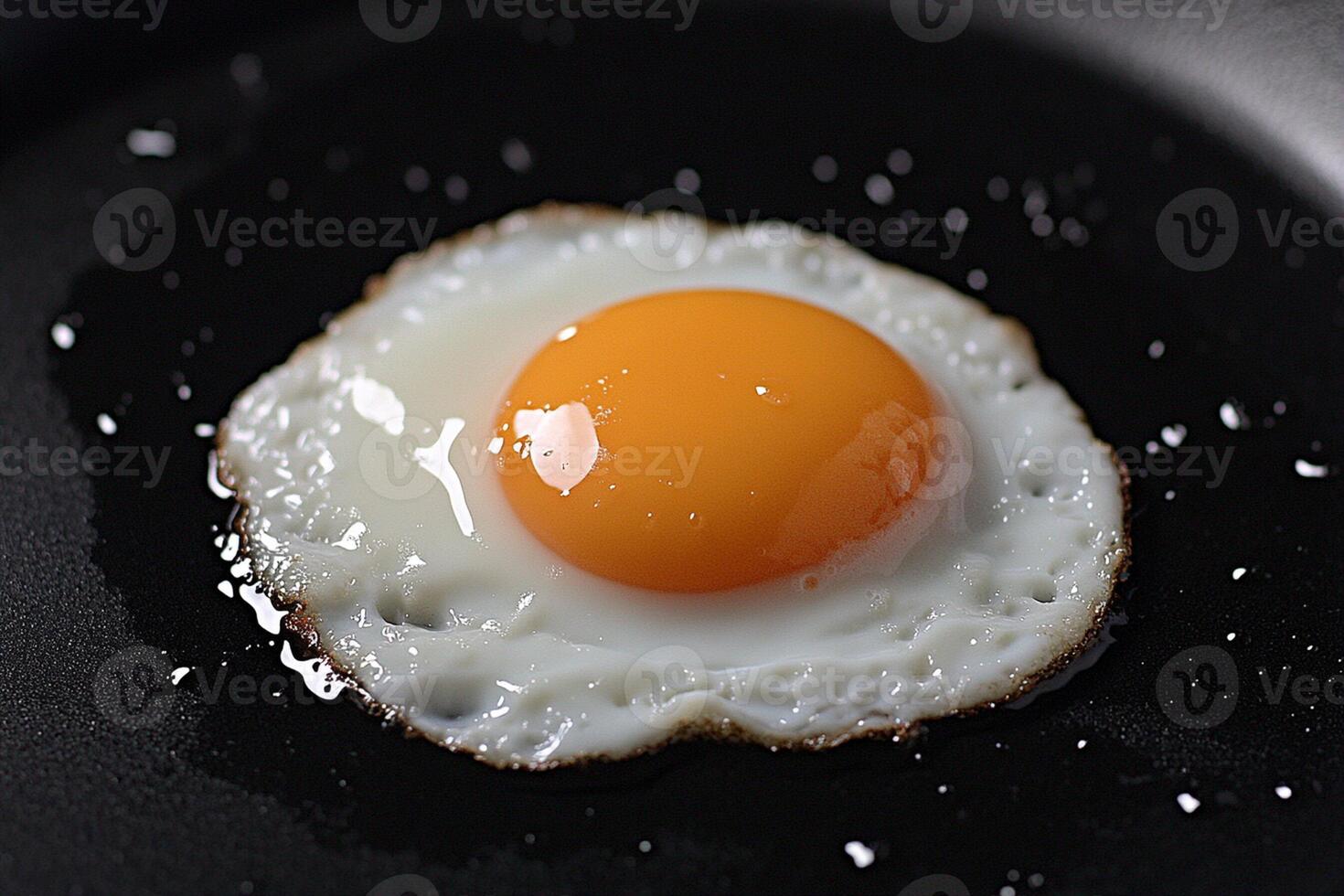 An egg is fried in a frying pan photo