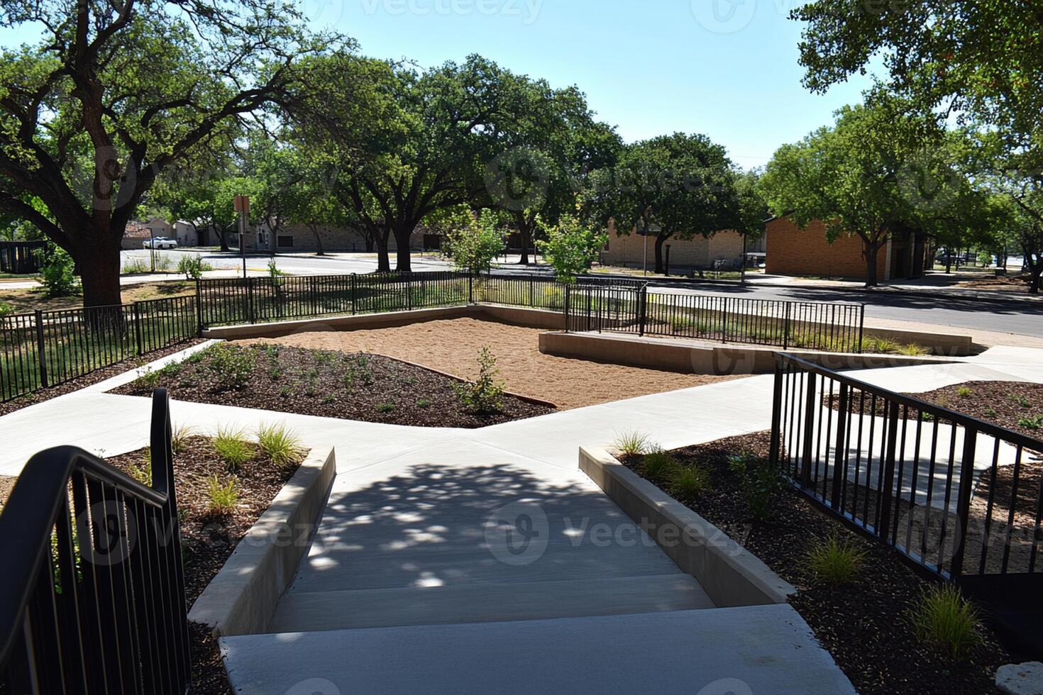 A view of a park with a bench and a walkway photo