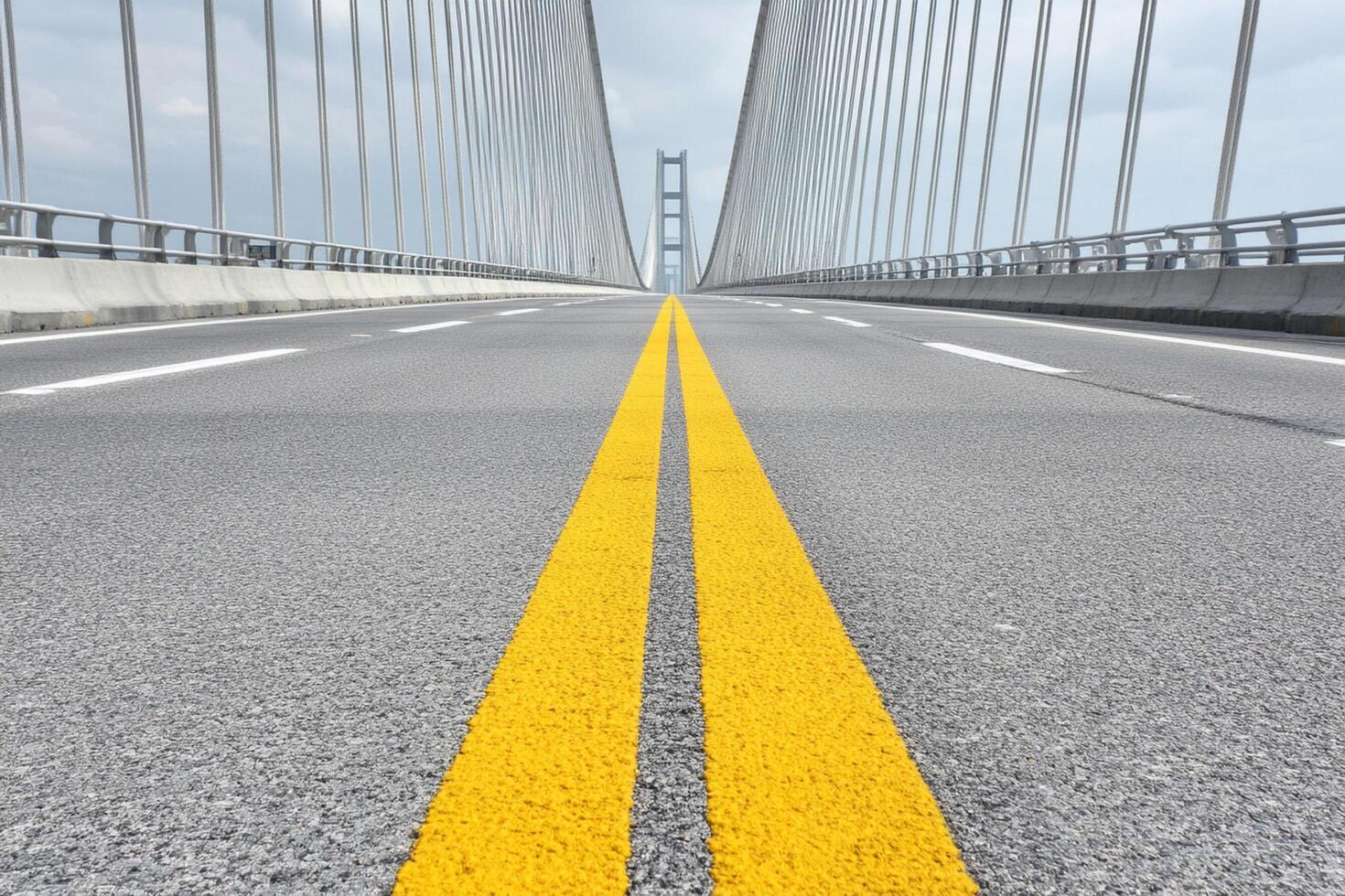 A yellow line on the side of a bridge photo