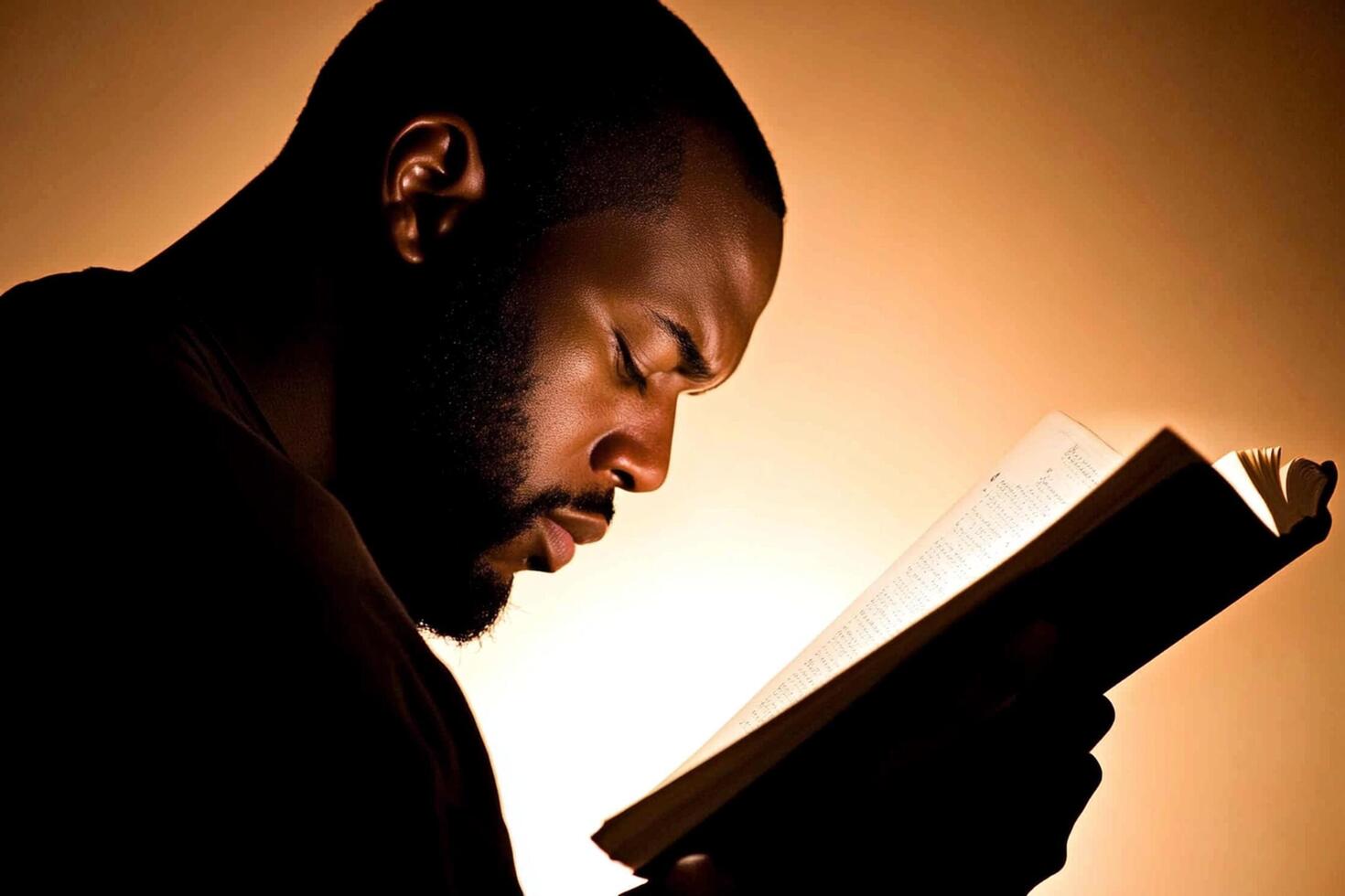 A man reading a book in the dark photo