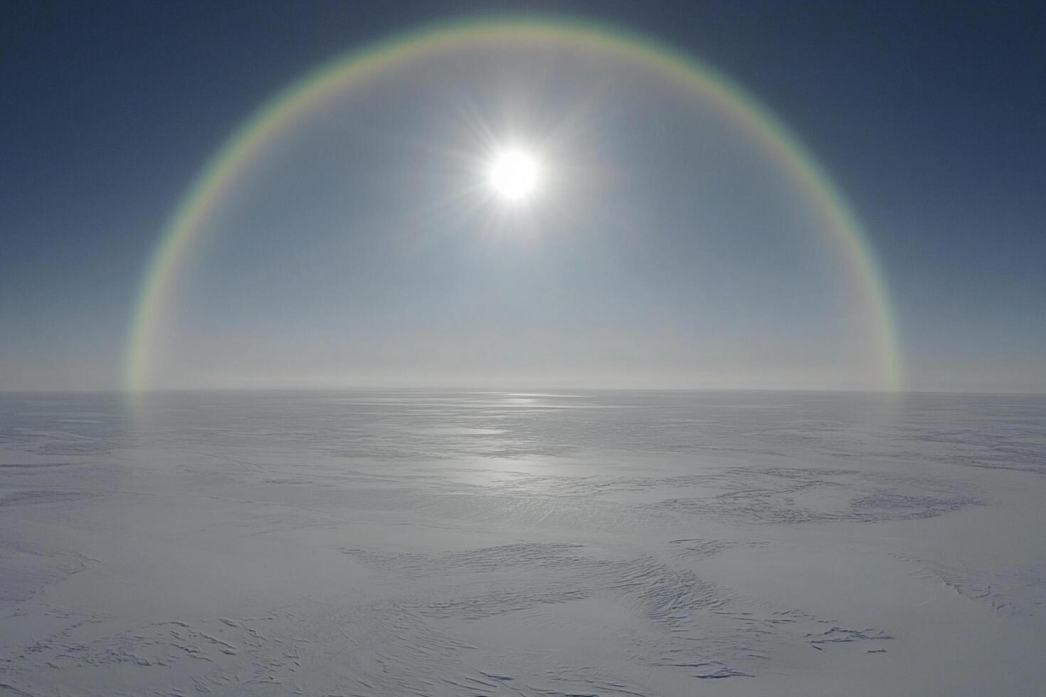 A rainbow over the snow covered ground photo