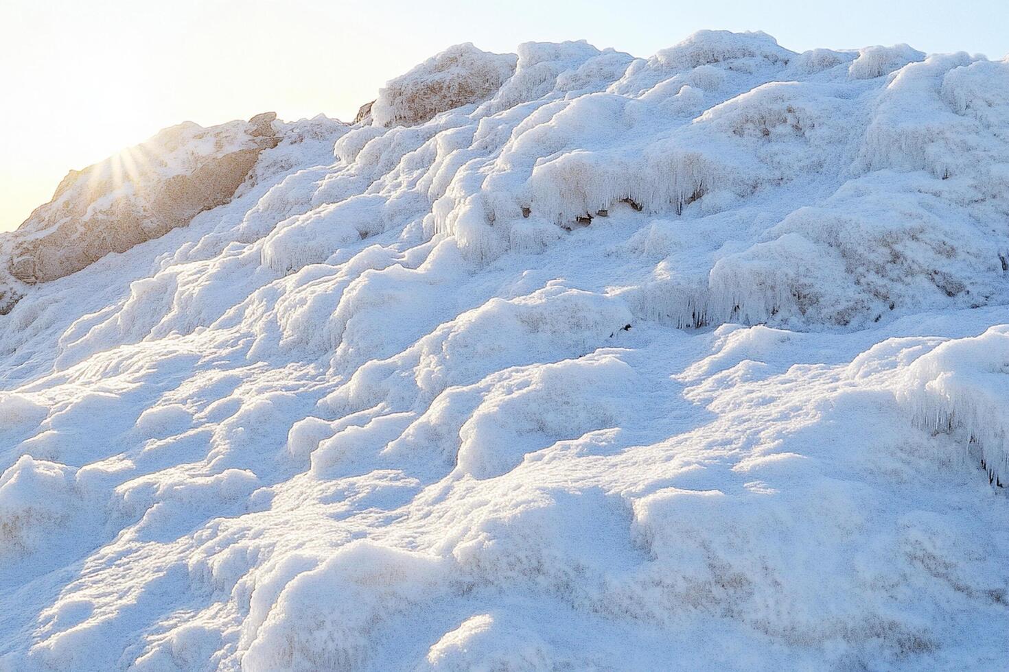 A person standing on top of a mountain covered in snow photo