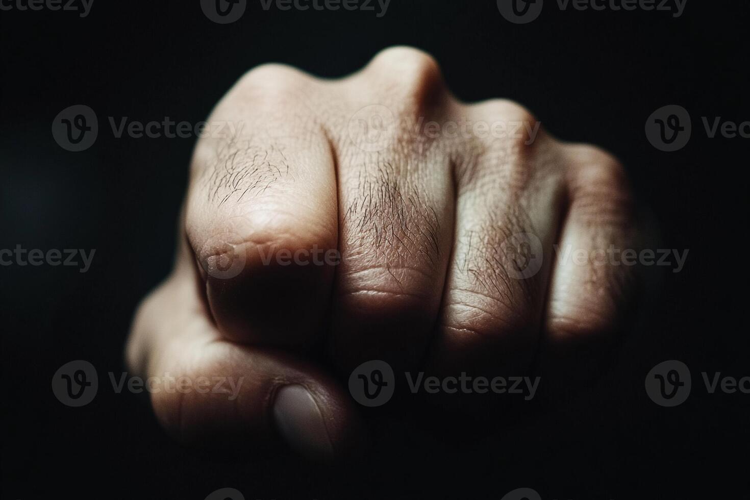 A close up of a man's fist on a black background photo
