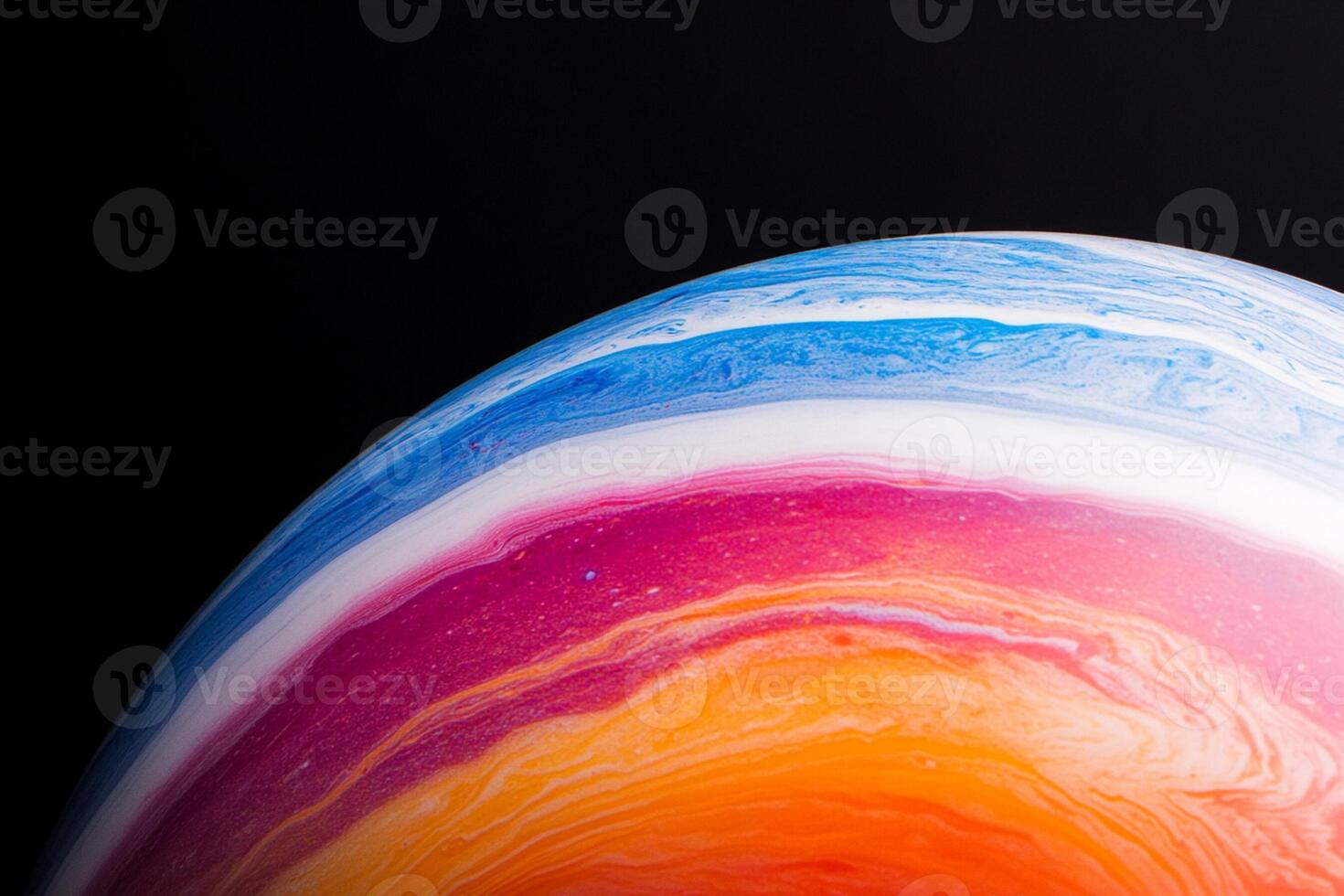 A colorful, multi - colored marble on a black surface photo