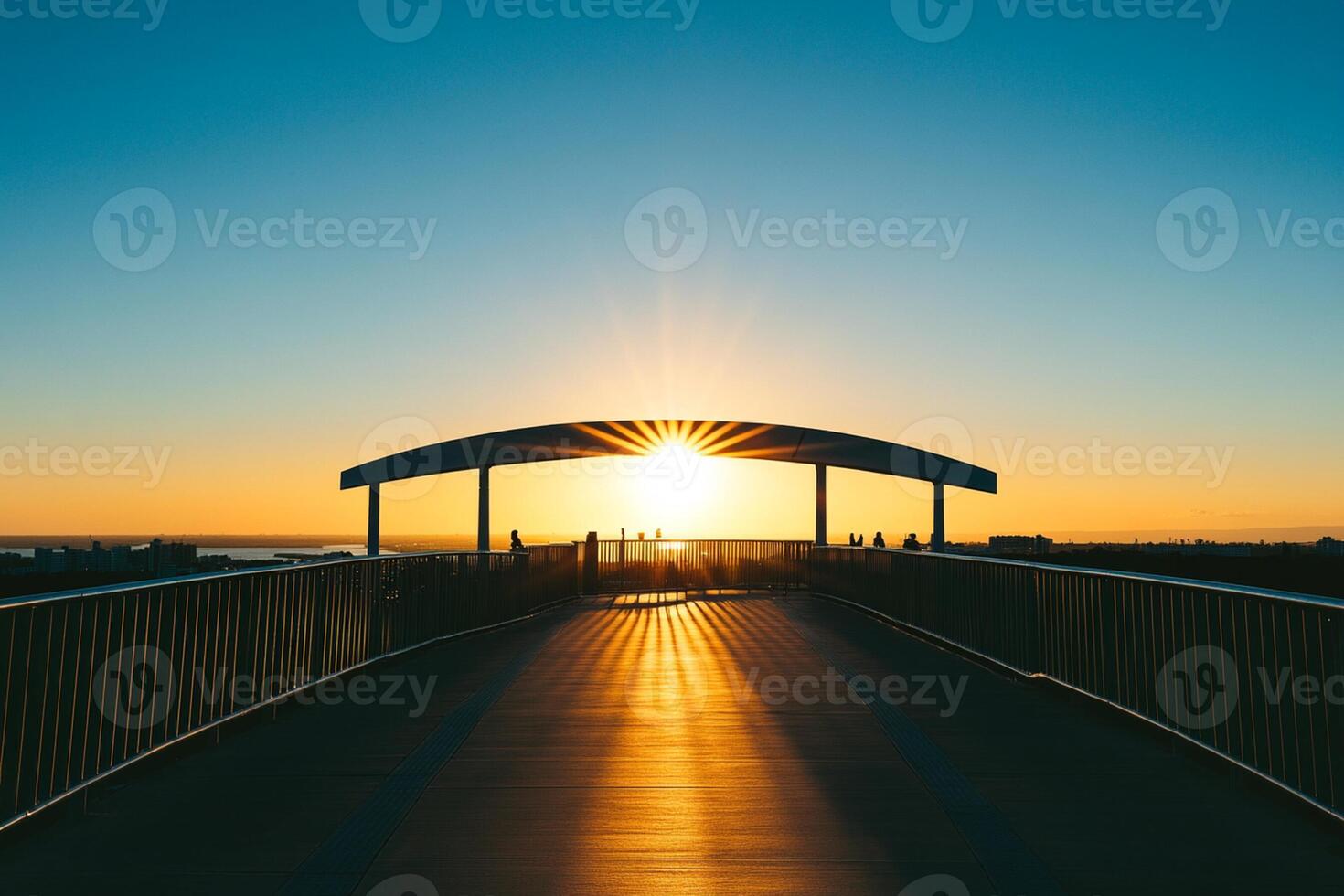 A bridge with a sun setting behind it photo