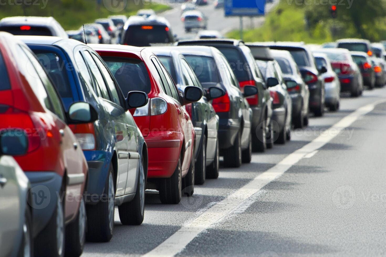 Many cars are lined up on the side of the road photo