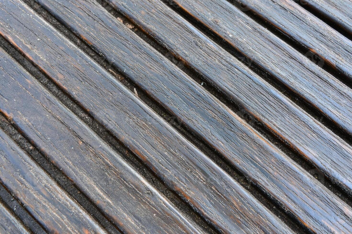 A close up of a wooden deck with a black and white striped pattern photo