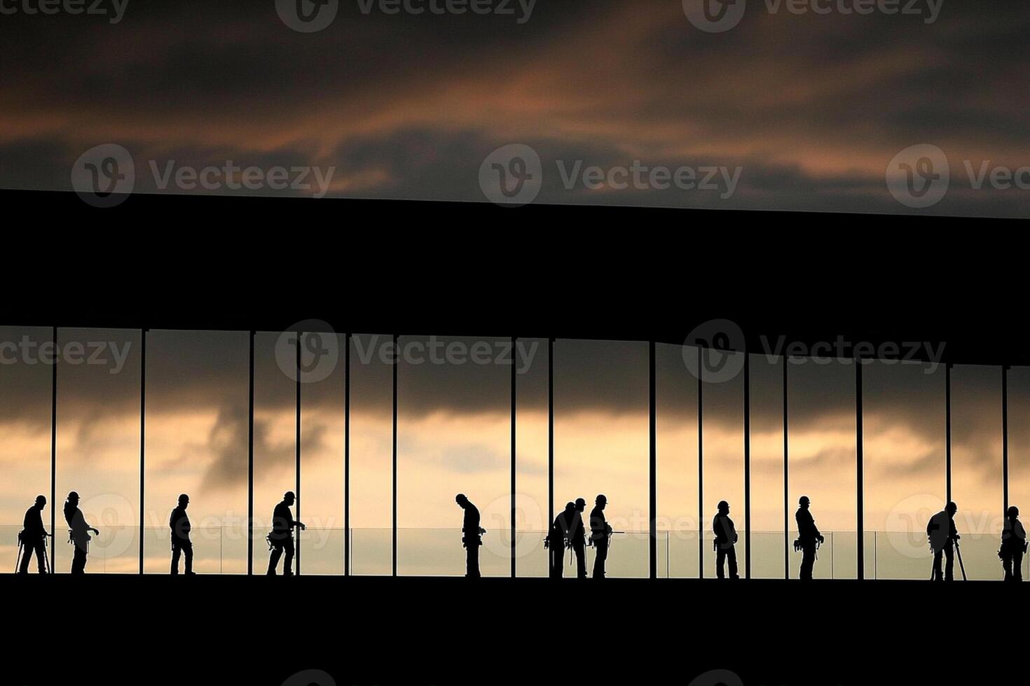 Silhouettes of people standing in front of a building photo