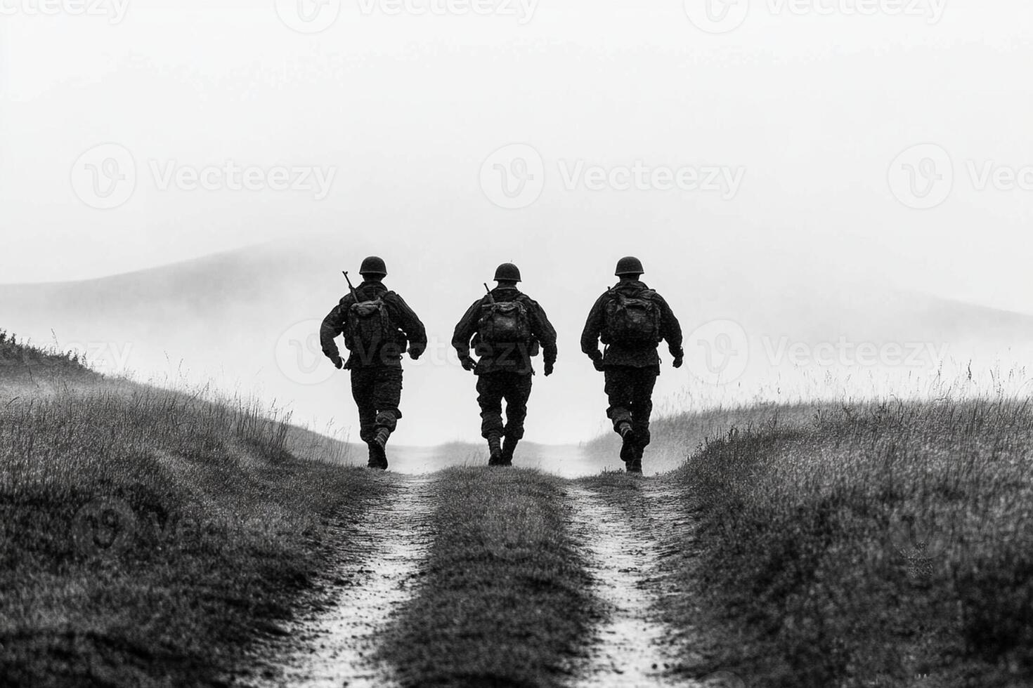 Three soldiers walking down a dirt road photo